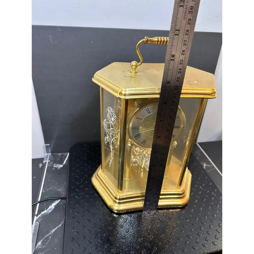 vintage German mantle clock with gold hexagonal glass case and etched roses.